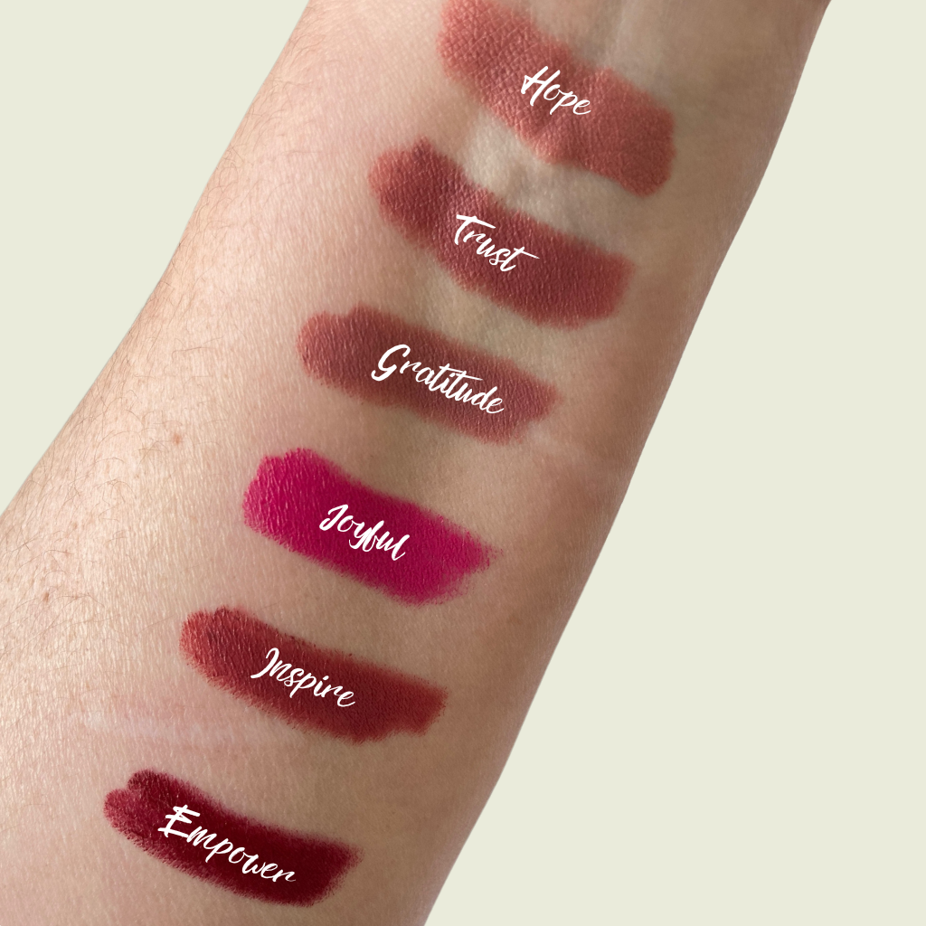 An arm swatch of various lipsticks in different shades.